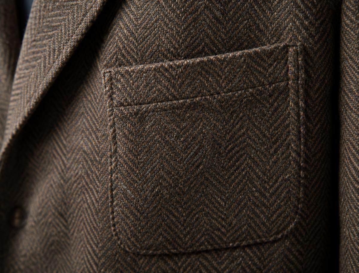 Close-up of a patch pocket on a brown herringbone tweed sports jacket