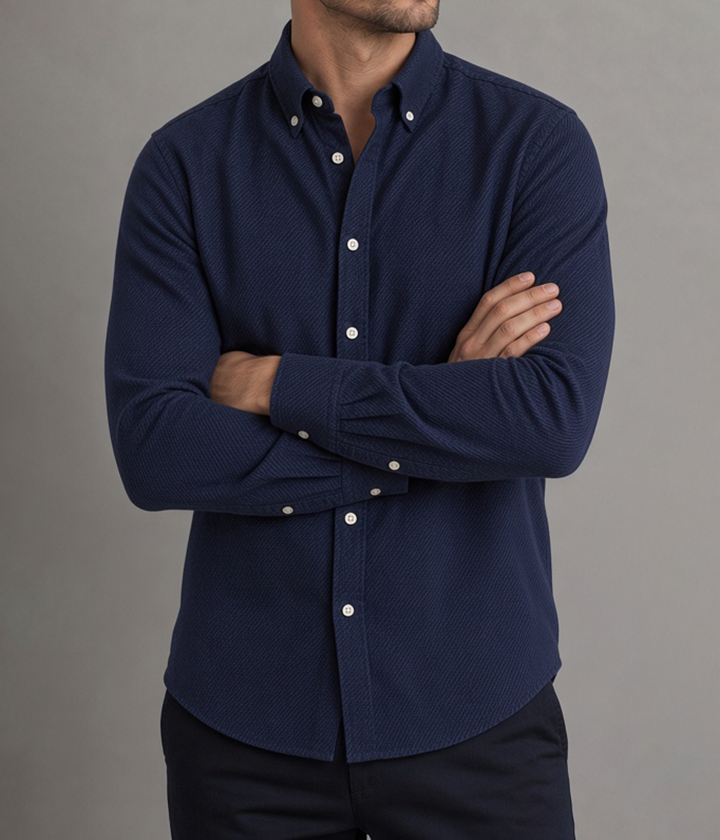 Man wearing a navy brushed twill flannel shirt, button-down collar, arms crossed