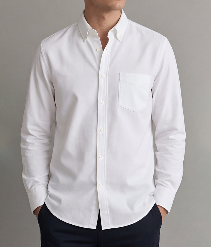 Man in a crisp white button-down oxford shirt with chest pocket